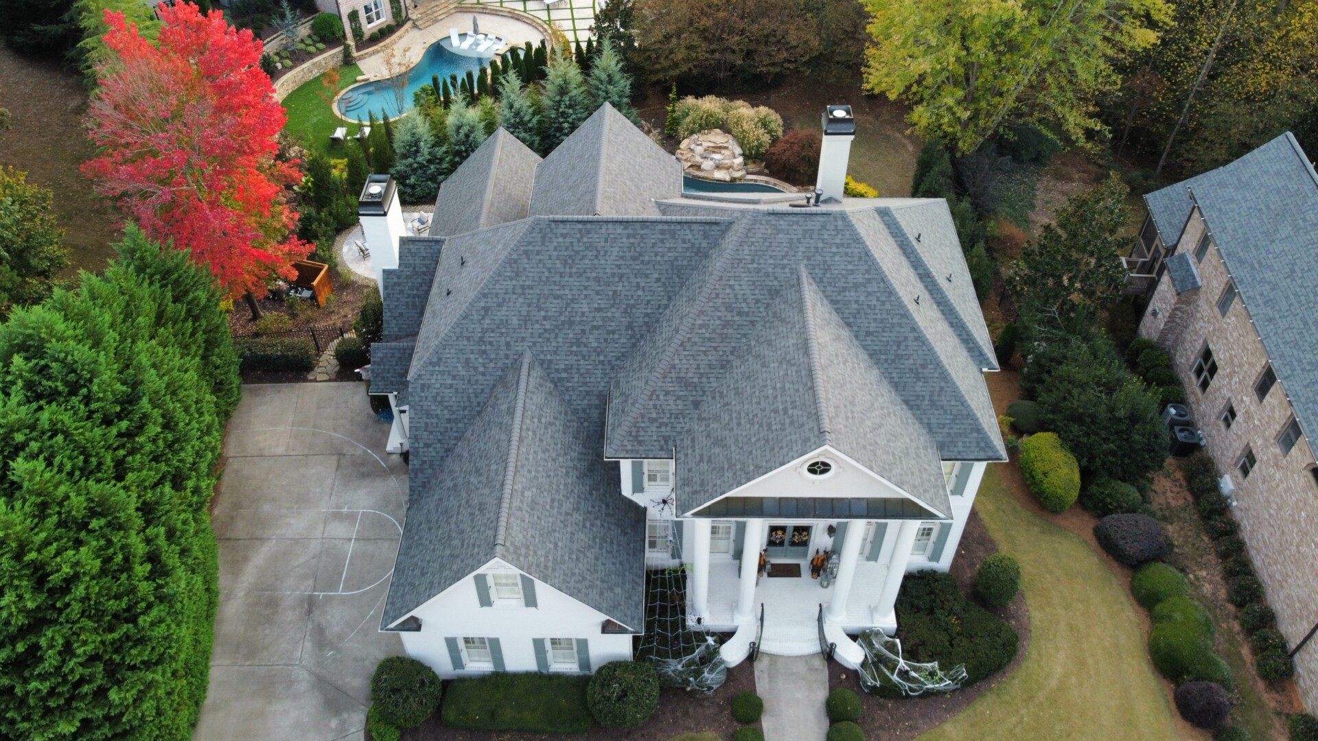 An aerial view of a home in a neighborhood.