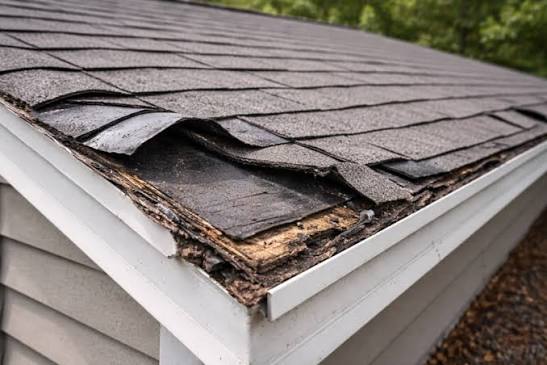 Roofing crew performing systematic tear-off exposing deck for inspection at Alpharetta, GA home