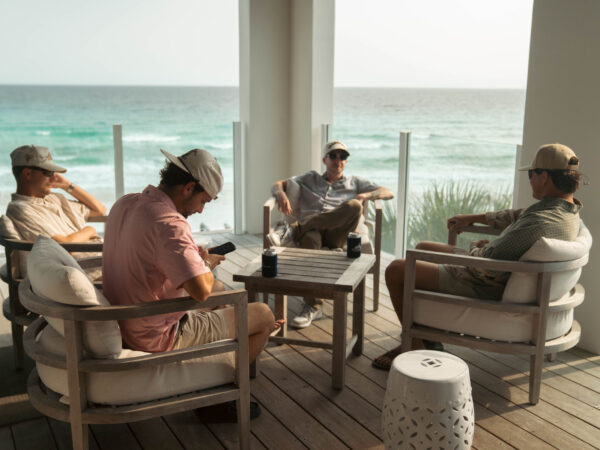 Top Sales Beach Trip 2026 – 16 Team relaxing on the beach house porch